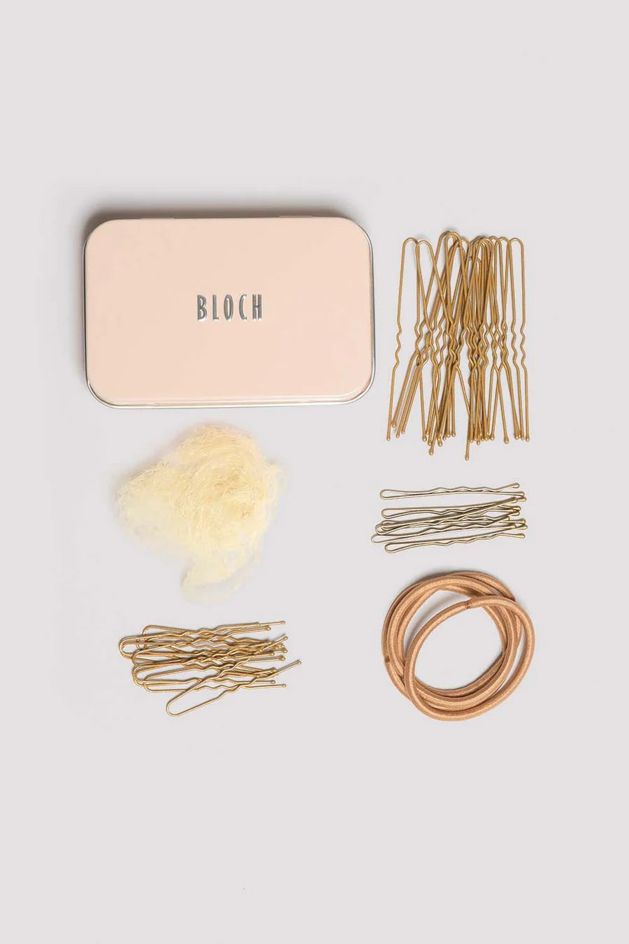 Collection of blond hair accessories including bobby pins, hair ties, and a beige container labeled BLOCH on a light gray background.