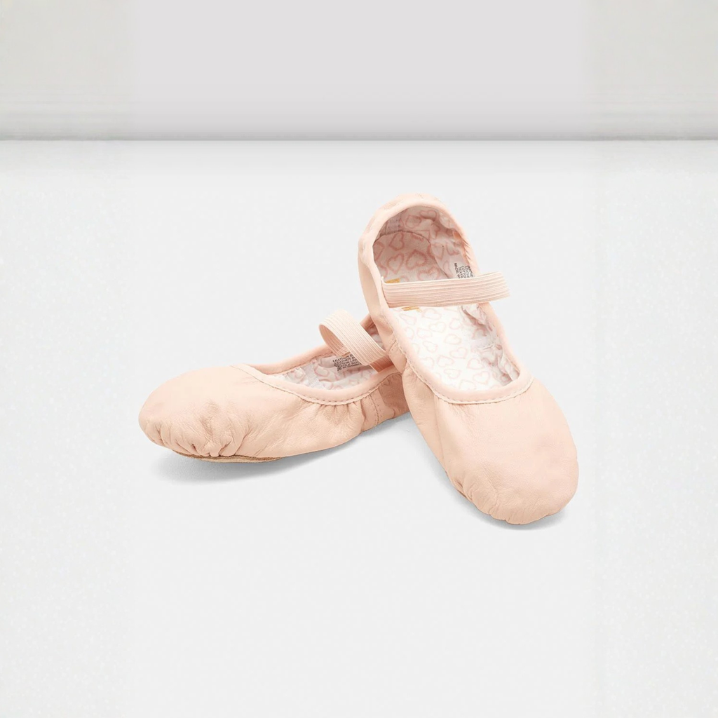 Bloch S0227G Children Belle Leather Ballet Shoe Side, Front, and Inside View. The inside displays a white fabric with pink small hearts throughout. In addition, this style is full sole and has one elastic strap.