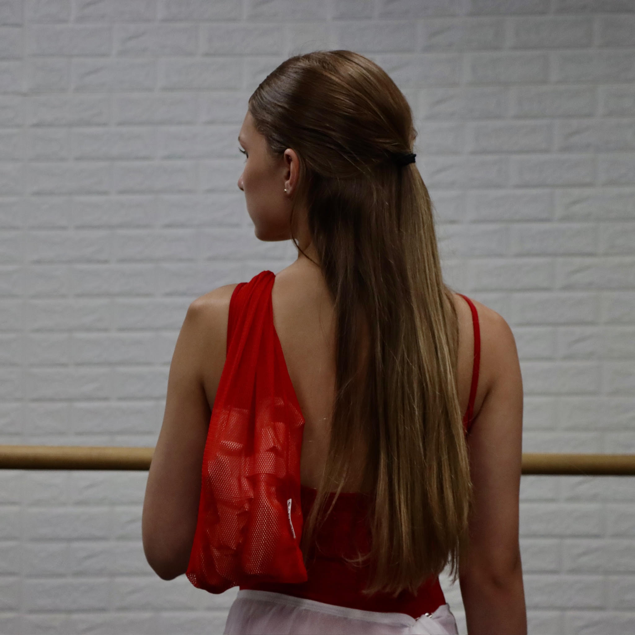 Women with red Capezio pointe shoe bag.