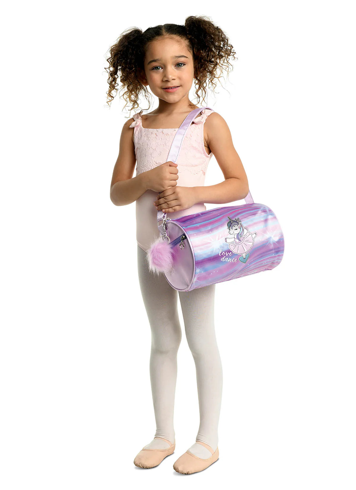 Girl holding a Danz N Motion purple, pink, and blue love dance unicorn duffle bag.