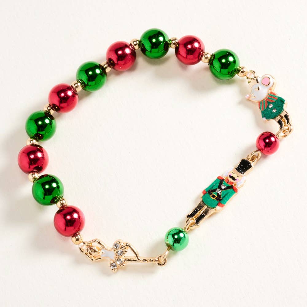Faire C6B2649 Influence gold bracelet with red and green beads with a ballerina, mouse, and nutcracker figure.
